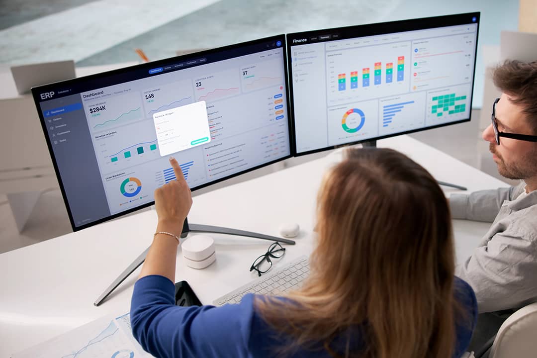 Corporate analysts reviewing a dashboard of an enterprise resource planning (ERP) software in preparation for an accounts payable policy.
